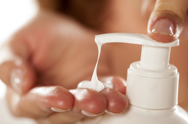 woman pumping pain relief lotion into her hand